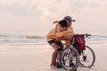 Hug of father for helping teenager boy on wheelchair