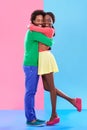 Hug, love and black couple with marriage, care and romance on a color block studio background. Relationship, embrace and Royalty Free Stock Photo