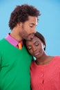 Hug, love and black couple with marriage, happy and romance on a blue studio background. Relationship, embrace and man Royalty Free Stock Photo