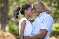 Hug, love or happy black couple in nature to relax or bond on holiday vacation together to travel. Romantic, eye contact