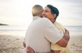 Hug, love and senior couple at beach happy, relax and bond in nature together. Ocean, embrace and old people hugging at