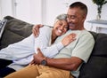 Hug, marriage and senior woman or man on sofa with love or care in home to relax. Retirement, smile and elder couple Royalty Free Stock Photo