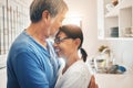 Hug, smile and mature couple kiss in home for care, support or trust together. Embrace, happy man and woman in kitchen Royalty Free Stock Photo