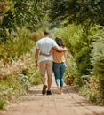 Hug, walk and couple on a path in nature for peace, relax and bonding together in summer. Back of a man and woman with Royalty Free Stock Photo