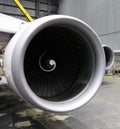 a huge aircraft engine during maintenance inside a hangar
