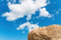 Huge ancient boulder against the blue sky scene