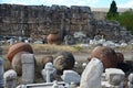 Huge antique clay amphoras against the backdrop of the ruins of the ancient city of Hierapolis near Pamukkale Royalty Free Stock Photo