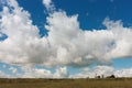 A huge beautiful cloud over a small house. Tyva. Steppe. Sunny summer day Royalty Free Stock Photo