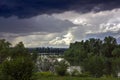 Huge black rain clouds over the river and the city Royalty Free Stock Photo