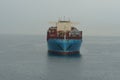 Huge blue container vessel from shipping company Maersk Lines anchored at calm sea near to port of Koper.