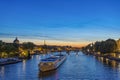 Huge Boats Cruises Over Seine River in Paris at Twilight Sunset With Eiffel Tower Royalty Free Stock Photo