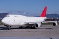 Huge Boeing 747-400 Jumbo Jet freighter with red tail on the ground Royalty Free Stock Photo