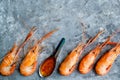 Huge boiled delicious king prawns on a gray background close-up, flat lay, copy space