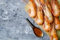 Huge boiled delicious king shrimps on a gray background close-up, copy space, flat lay