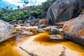 Huge boulders covered in orange - brown dye at Tidal River.