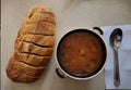 Huge bread sliced and bowl of soup