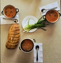 Huge bread sliced and bowls of soup