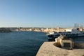 Valletta, Malta, August 2019. Cargo ship passing by a war memorial. Royalty Free Stock Photo