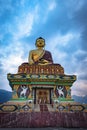 Huge buddha golden statue from different perspective with moody sky at evening Royalty Free Stock Photo