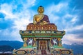 Huge buddha golden statue from different perspective with moody sky at evening Royalty Free Stock Photo