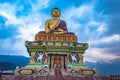 Huge buddha golden statue from different perspective with moody sky at evening Royalty Free Stock Photo