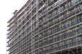 Huge building facade with scaffolding, construction site