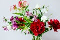 Huge bunch of peonies and others spring flowers in vase on white