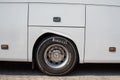 Huge bus wheel with a shiny disc. White bus wheel arch. Pirelli tire