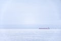 A huge cargo ship makes it way through the sea