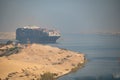 Huge cargo ships navigate through Suez Canal. Shipping canal in Egypt. Concept of transportation and logistics