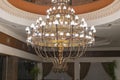 Huge chandelier in the hall. Chandelier on decoarted ceiling of a ballroom Royalty Free Stock Photo