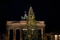 Huge Christmas tree with shiny golden balls and lights in front of Brandenburg Gate in Berlin Germany. Night scene of New Year Royalty Free Stock Photo