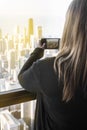 Huge city chicago skyline sunset with woman taking photos Royalty Free Stock Photo