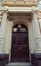 Huge classical antic door made of wood with many ornaments