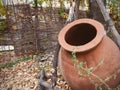 huge clay jug in the autumn courtyard near the old house, background wallpaper Royalty Free Stock Photo