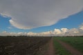 Huge cloud over an empty countryside road. Royalty Free Stock Photo