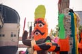 Huge colorful ravana effigy with a sword and a shield placed on the side of a busy street