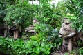 Huge concrete carved Statue of pacific islander man holding fish in jungle