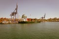 Huge cranes load a ship on the sea freight loading platform.