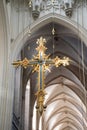 Huge Cross hanging down in Cathedral with arches