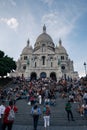 Huge crowd gather on the stairs in front of The Basilica of the Sacred Heart of Paris, Vertical shot