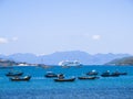 A huge cruise ship and a group of wooden fishing ships