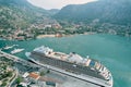 Huge cruise ship is moored off the coast in a bay with mountains in the background. Drone Royalty Free Stock Photo