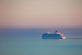 Huge cruise ship seascape eclipses the foggy horizon at sunset Royalty Free Stock Photo