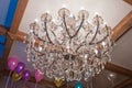 Huge crystal glass chandeliers hanging on ballroom . Large crystal chandelier with pendants in ceiling.