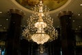 Huge crystal glass chandeliers hanging on ballroom dance in wedding ceremony date, decorated by Victorian style Royalty Free Stock Photo