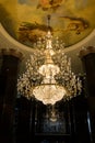 Huge crystal glass chandeliers hanging on ballroom dance in wedding ceremony date,decorated by victorian style Royalty Free Stock Photo