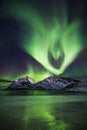 Huge display of green color fill the sky in Lofoten, Norway