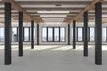 A huge empty room with large windows overlooking the metropolis, iron columns and wooden beams in the loft style. Concrete floor
