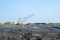 A huge excavator carries rock from the unloaded train from the mine. The concept of mining and environmental problems.